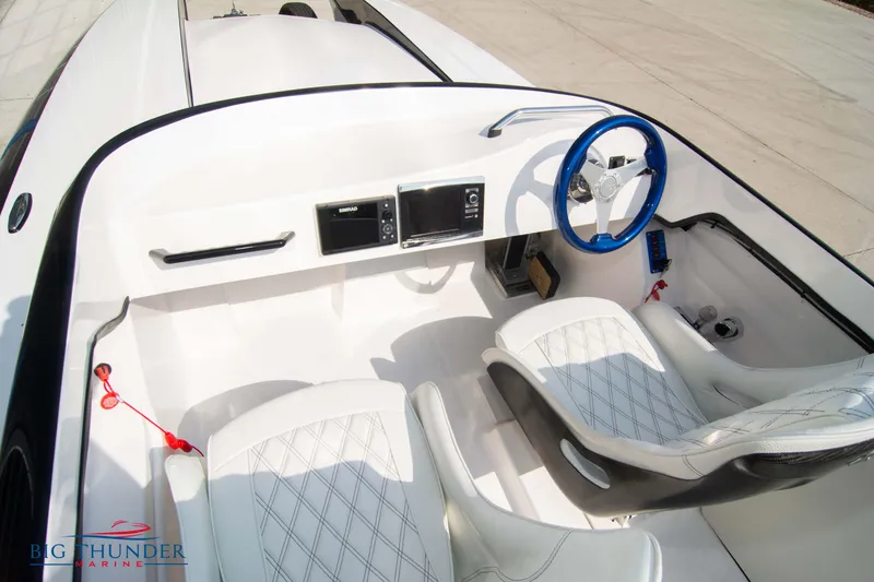 Slide: The Image of 2019 Spectre Screaming Eagle 22 Talon boat interior with white seats and blue steering wheel. - 25