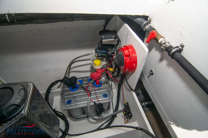 Slide: The Image of 2019 Spectre Screaming Eagle 22 Talon engine compartment with battery and wiring. - 41