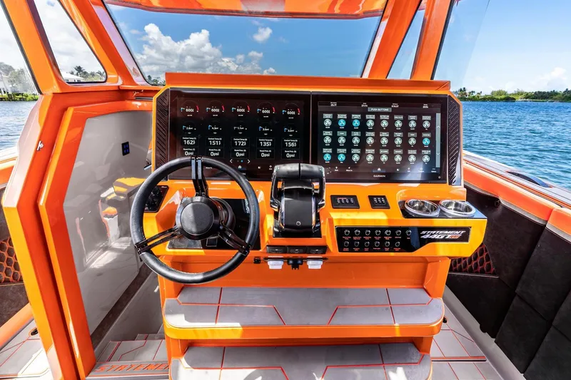 Slide: The Image of Orange helm of 2026 Statement 47 GTrs boat with advanced digital controls. - 10