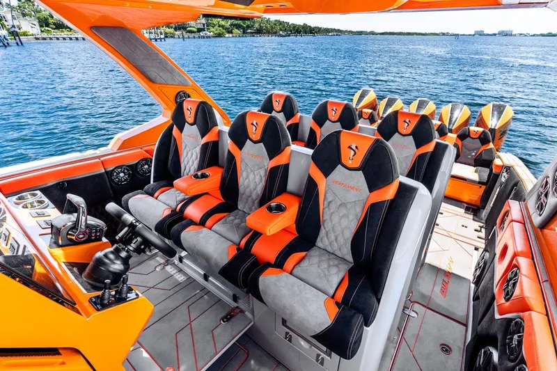 Slide: The Image of Luxurious 2026 Statement 47 GTrs boat interior with orange and black seating, on a scenic water backdrop. - 13
