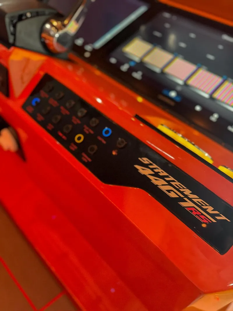 Slide: The Image of Control panel of a 2025 Statement 44 GTrs with digital display and vibrant orange design. - 14