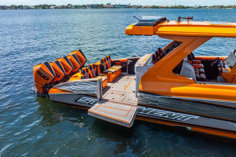 Slide: The Image of Orange 2026 Statement 47 GTrs boat with multiple powerful engines on a calm lake. - 2
