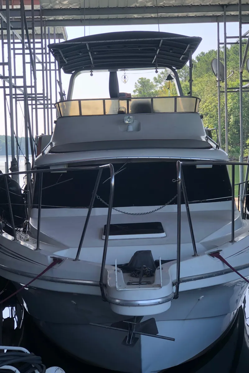 Slide: The Image of 1990 Bluewater Sedan boat docked in a marina. - 1