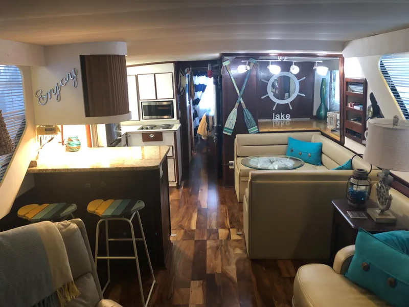 Slide: The Image of Interior of a 1990 Bluewater Sedan with modern decor and wooden flooring. - 20