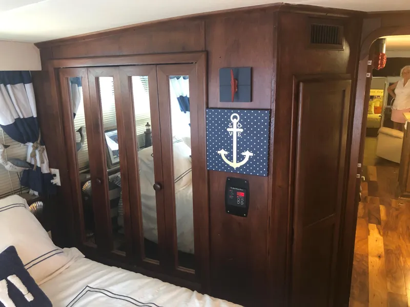 Slide: The Image of 1990 Bluewater Sedan interior with wooden closet and nautical decor. - 33