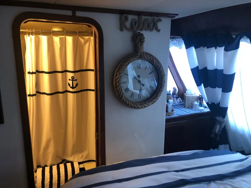Slide: The Image of Nautical-themed interior of a 1990 Bluewater Sedan with anchor shower curtain and rope clock. - 35