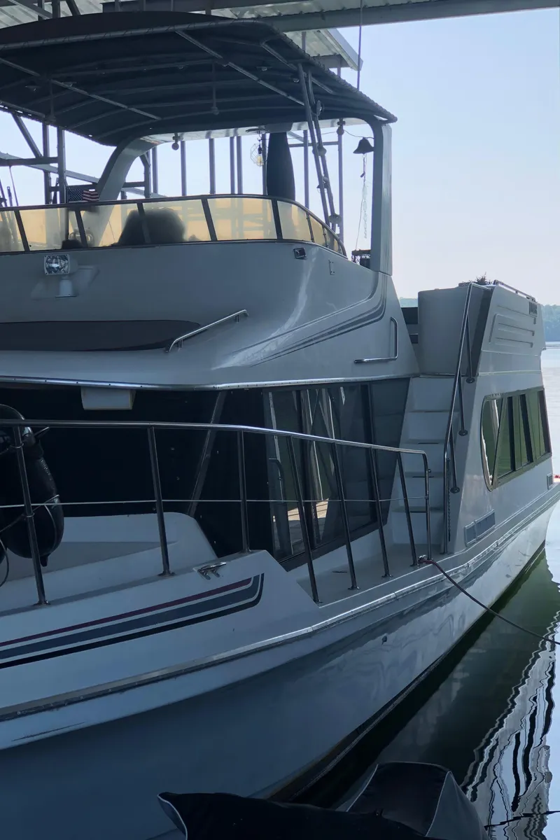 Slide: The Image of 1990 Bluewater Sedan boat docked in a marina. - 4