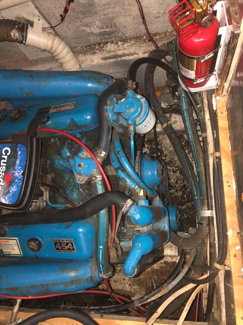 Slide: The Image of 1990 Bluewater Sedan engine compartment with fire extinguisher and Crusader 454 engine. - 42