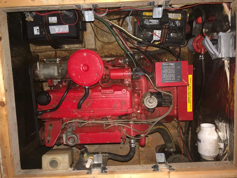 Slide: The Image of 1990 Bluewater Sedan engine compartment with red engine and battery setup. - 44