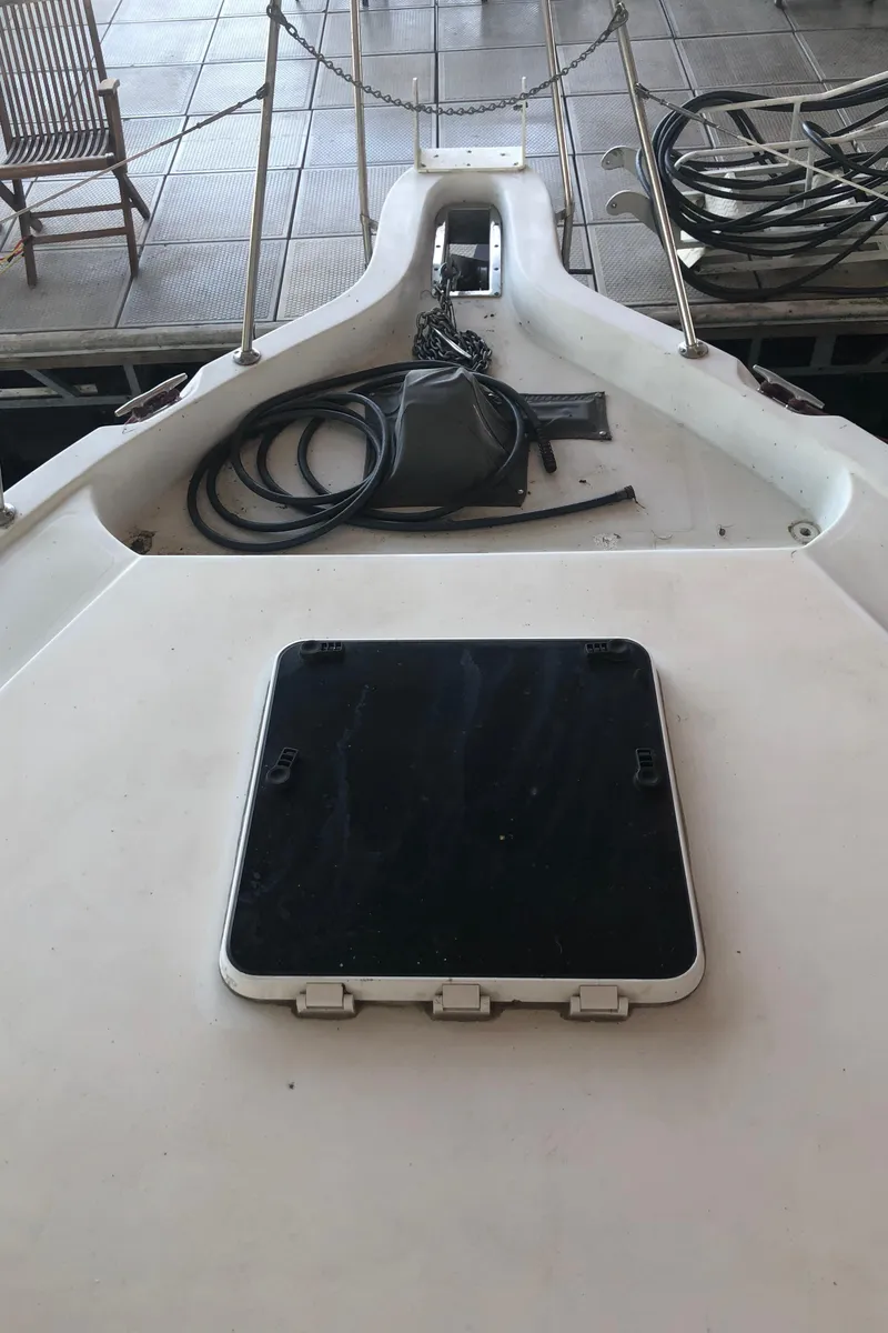 Slide: The Image of 1990 Bluewater Sedan boat deck with hatch and coiled ropes. - 9