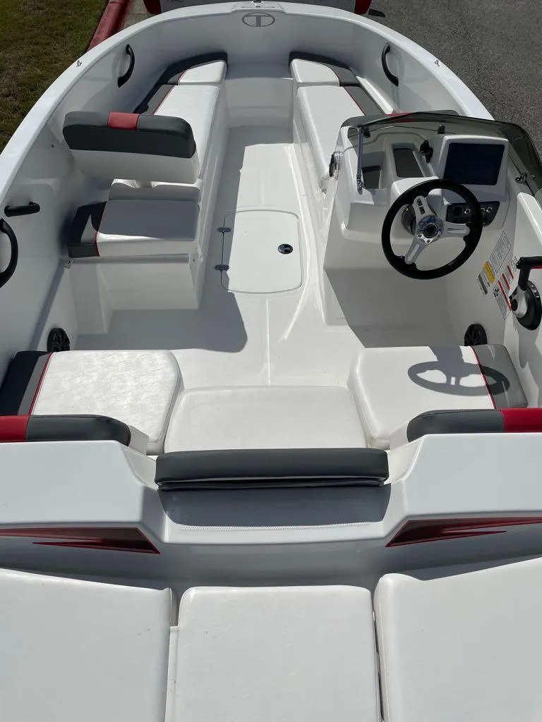 Slide: The Image of 2024 Tahoe T16 boat interior with seating and steering console. - 2