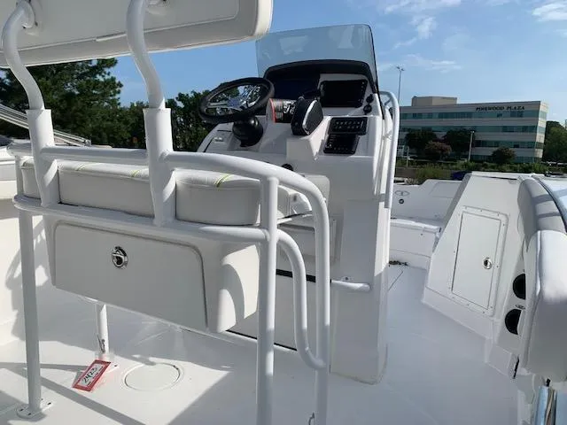 Slide: The Image of 2024 Tahoe 2150 CC boat interior with steering console and seating. - 3