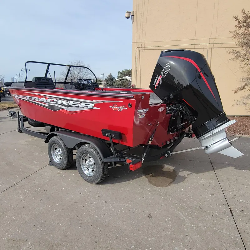 Slide: The Image of 2024 Tracker Targa V-19 WT boat on trailer, red with black motor. - 2