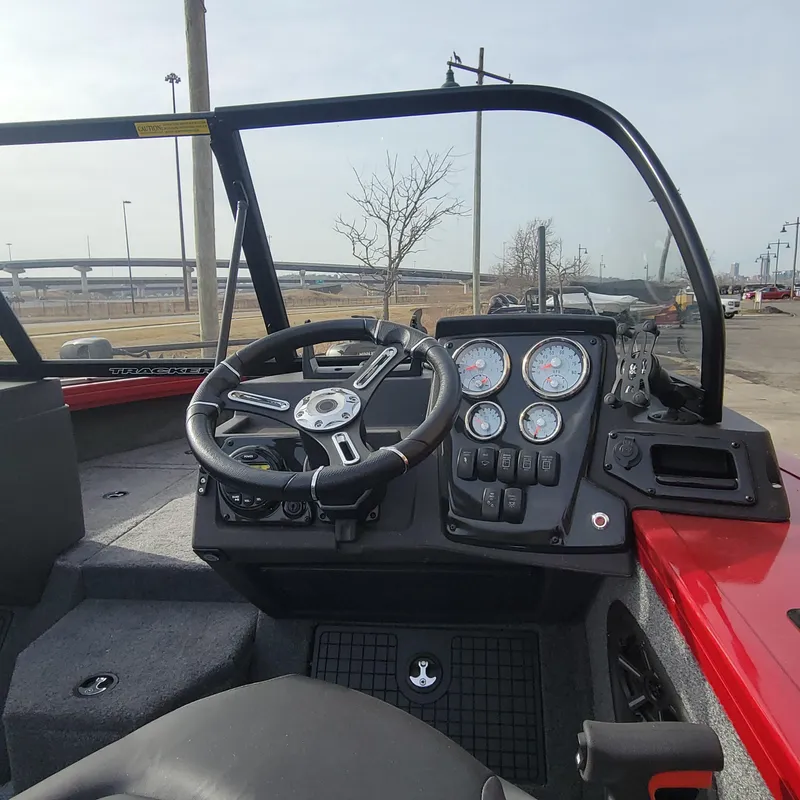 Slide: The Image of 2024 Tracker Targa V-19 WT boat dashboard with steering wheel and gauges. - 4