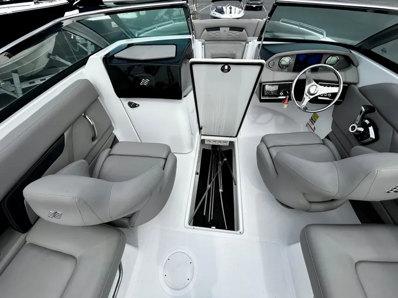 Slide: The Image of 2022 Four Winns HD5 OB boat interior with gray seating and modern dashboard. - 10