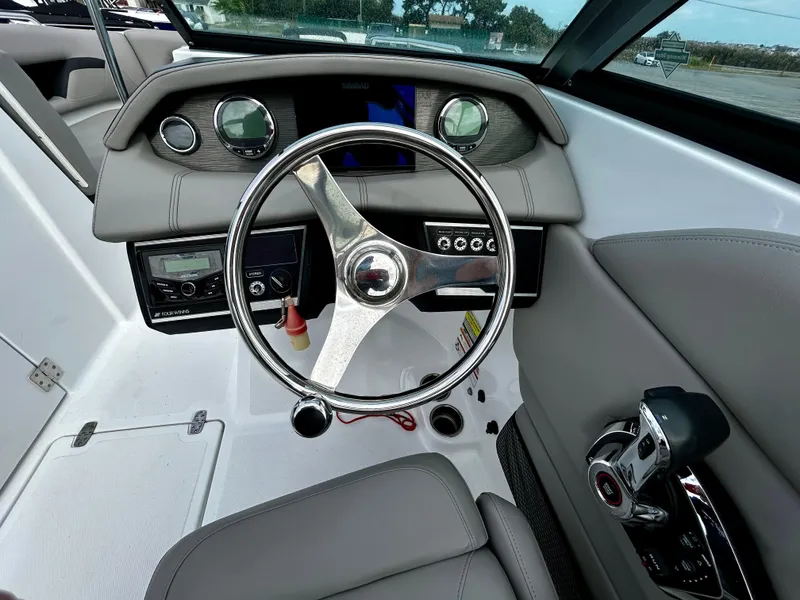 Slide: The Image of 2022 Four Winns HD5 OB boat dashboard with steering wheel and controls. - 15