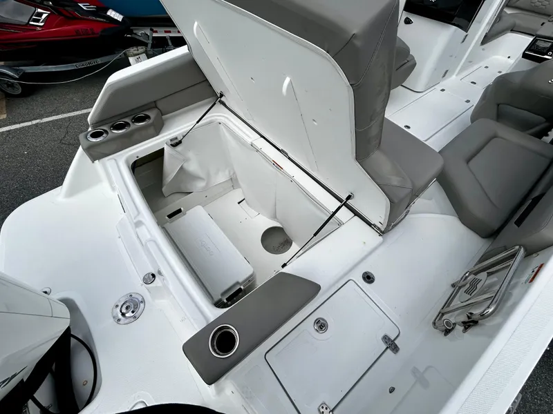 Slide: The Image of 2022 Four Winns HD5 OB boat interior with open storage compartment and seating. - 18