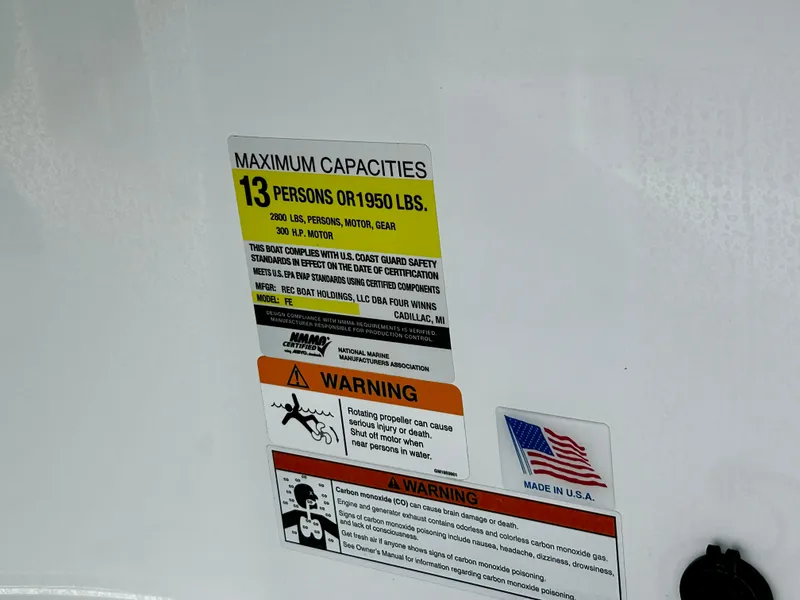 Slide: The Image of 2022 Four Winns HD5 OB capacity label, 13 persons or 1950 lbs, safety warnings, Made in USA. - 19