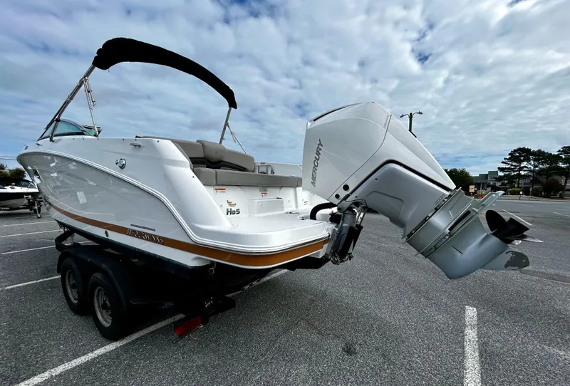 Slide: The Image of 2022 Four Winns HD5 OB boat on trailer, featuring a powerful outboard motor. - 4