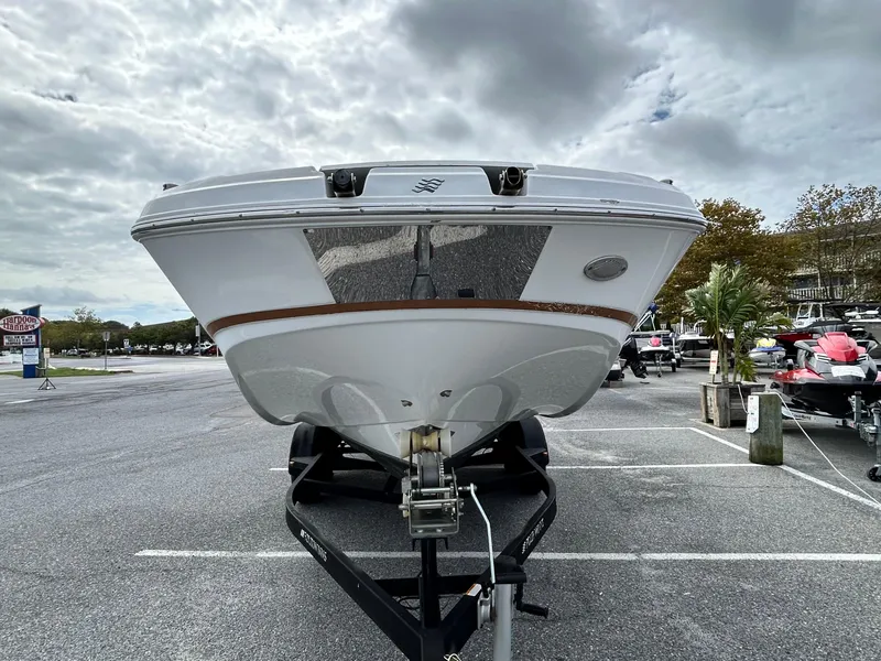 Slide: The Image of 2022 Four Winns HD5 OB boat on trailer, front view under cloudy sky. - 5