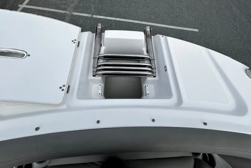 Slide: The Image of 2022 Four Winns HD5 OB boat with a folded swim ladder on the deck. - 8
