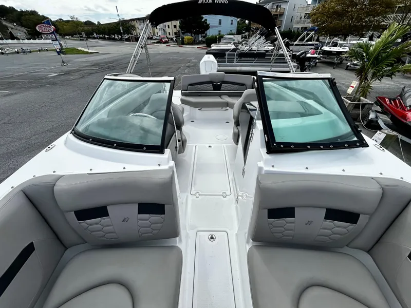 Slide: The Image of 2022 Four Winns HD5 OB boat interior with gray seating and open deck layout. - 9