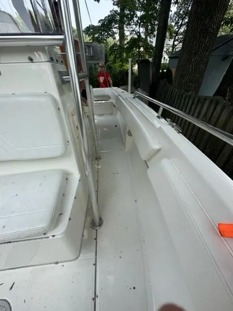 Slide: The Image of Interior view of a 2002 Fountain 25 C/C boat, white seats and railing. - 12