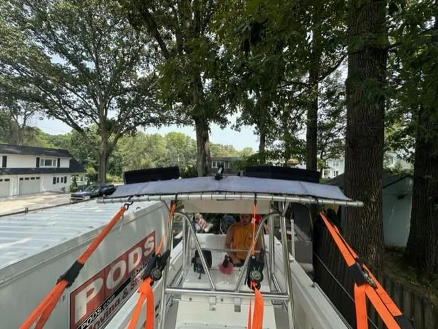 Slide: The Image of 2002 Fountain 25 C/C boat parked beside a PODS container. - 15