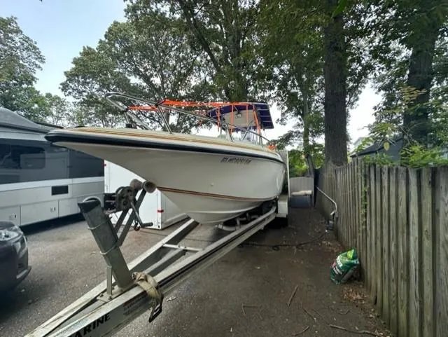 Slide: The Image of 2002 Fountain 25 C/C boat parked on trailer outdoors. - 2