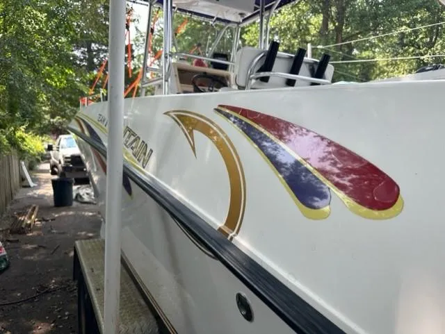 Slide: The Image of 2002 Fountain 25 C/C boat with colorful design outdoors. - 3