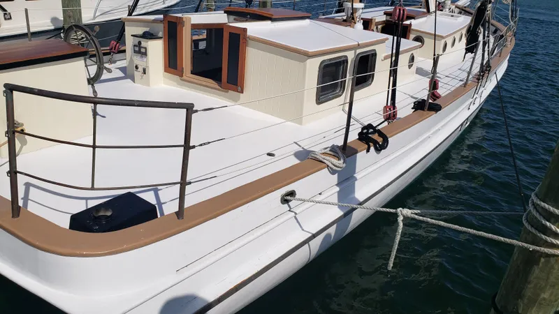 Slide: The Image of 1996 Custom Biloxi Schooner docked, showcasing deck and cabin details. - 10