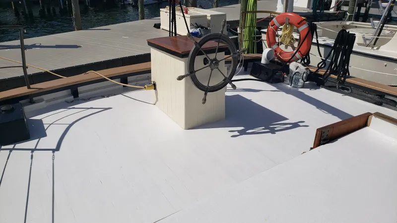 Slide: The Image of Deck of 1996 Custom Biloxi Schooner with steering wheel and lifebuoy. - 15