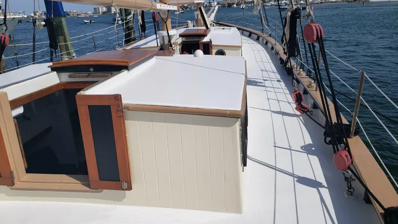 Slide: The Image of 1996 Custom Biloxi Schooner deck view with wooden hatches and ocean backdrop. - 17