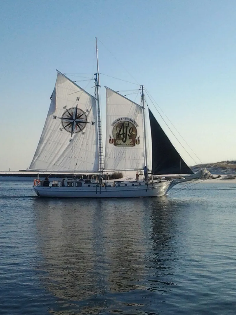 Slide: The Image of 1996 Custom Biloxi Schooner sailing on calm waters at sunset. - 3