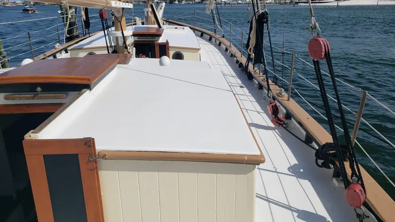Slide: The Image of Custom 1996 Biloxi Schooner deck with wooden accents and rigging, docked in a marina. - 31