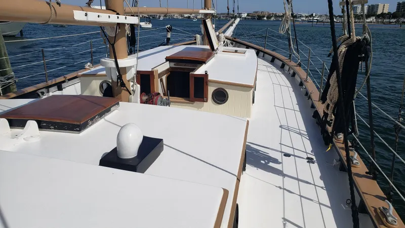 Slide: The Image of 1996 Custom Biloxi Schooner on calm waters, showcasing deck and cabin details. - 32