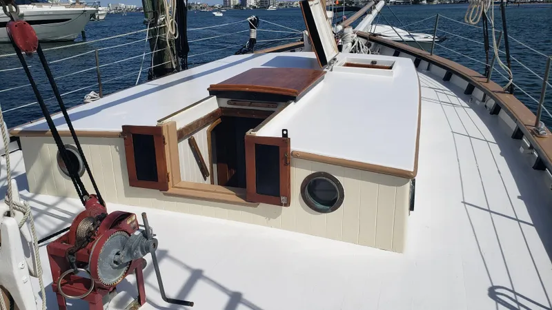 Slide: The Image of 1996 Custom Biloxi Schooner deck with open hatch, docked in a marina. - 37