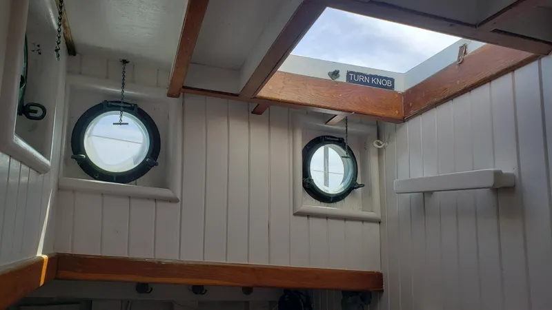 Slide: The Image of Interior of 1996 Custom Biloxi Schooner with portholes and wooden beams. - 42