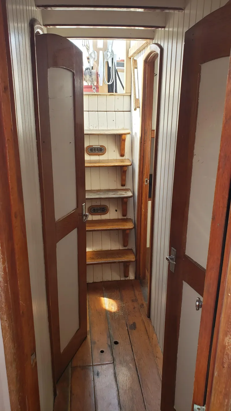 Slide: The Image of Interior of 1996 Custom Biloxi Schooner with wooden doors and steps. - 43