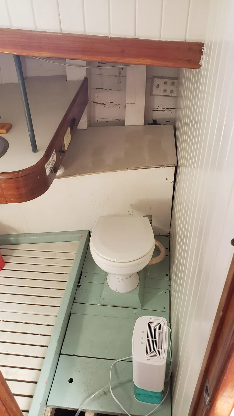 Slide: The Image of Compact bathroom on a 1996 Custom Biloxi Schooner with toilet and small heater. - 45
