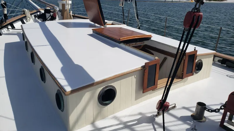 Slide: The Image of 1996 Custom Biloxi Schooner deck with open hatch, portholes, and rigging. - 49