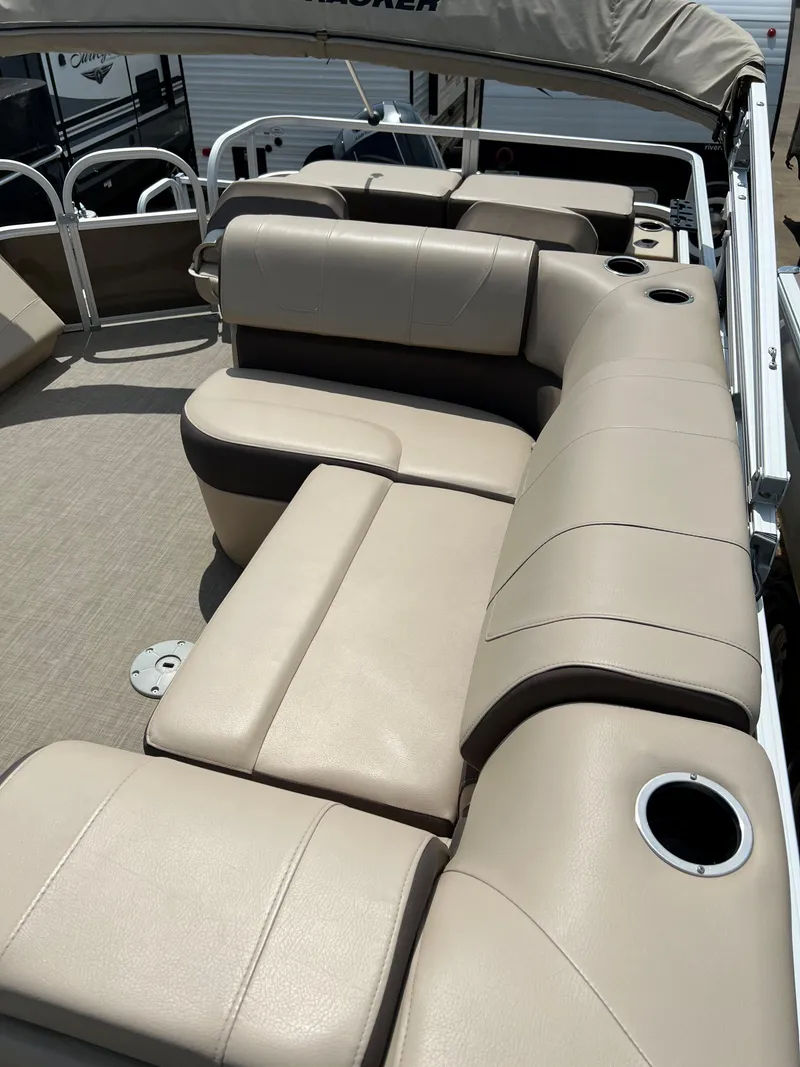 Slide: The Image of 2018 Sun Tracker SportFish 22 XP3 boat interior with beige seating and cup holders. - 13