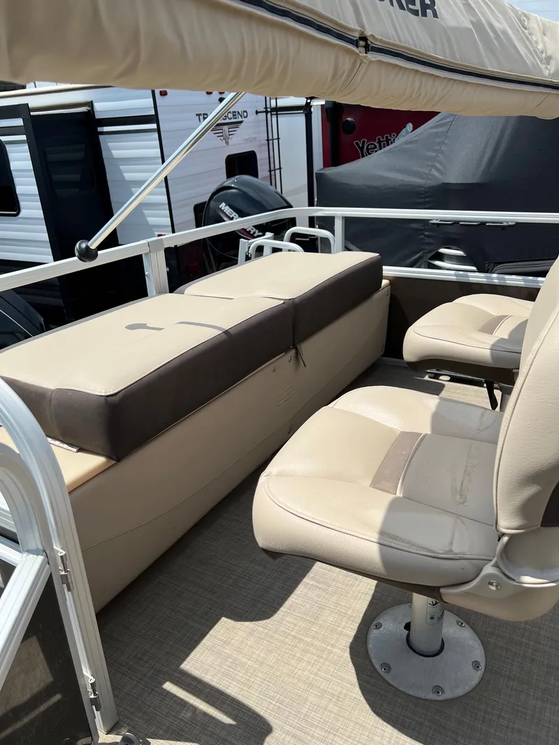 Slide: The Image of 2018 Sun Tracker SportFish 22 XP3 boat interior with beige seating and canopy. - 15