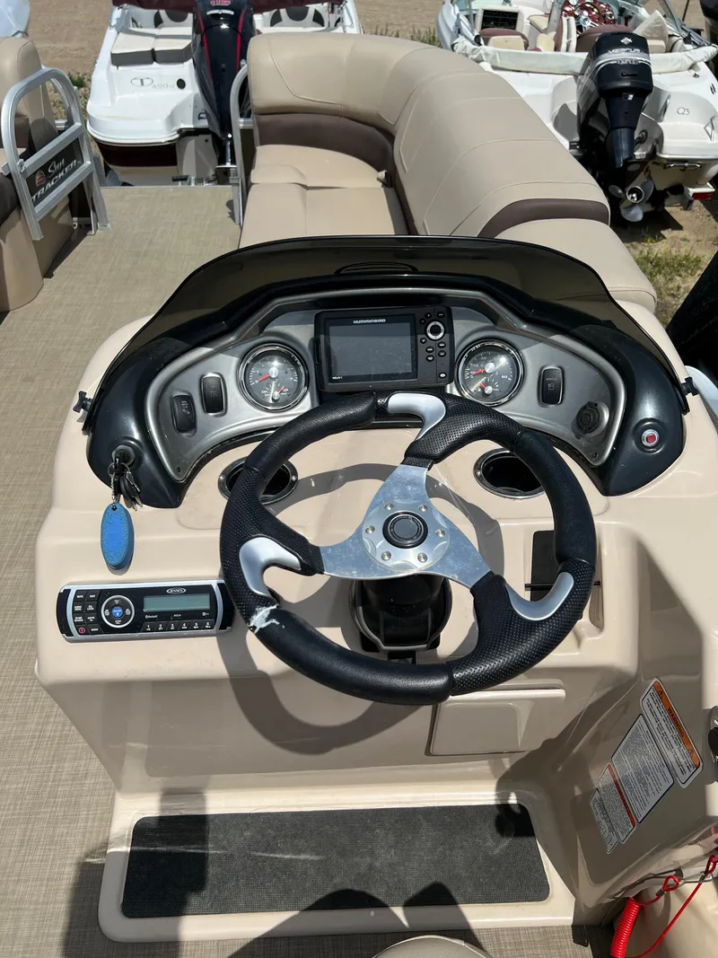 Slide: The Image of 2018 Sun Tracker SportFish 22 XP3 boat dashboard and steering wheel. - 8