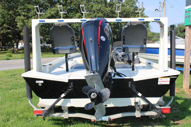 Slide: The Image of 2020 Lowe CAT 20 fishing boat with outboard motor and rod holders. - 3