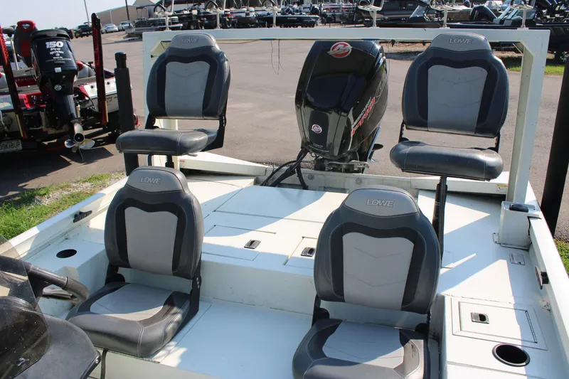 Slide: The Image of 2020 Lowe CAT 20 boat with four seats and an outboard motor. - 8