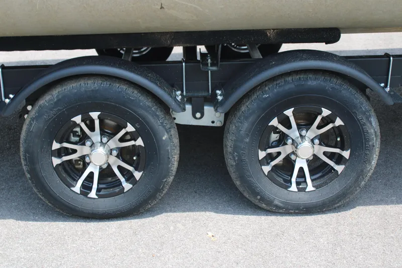 Slide: The Image of 2021 Lowe SS250 Super Sport trailer wheels on pavement. - 5