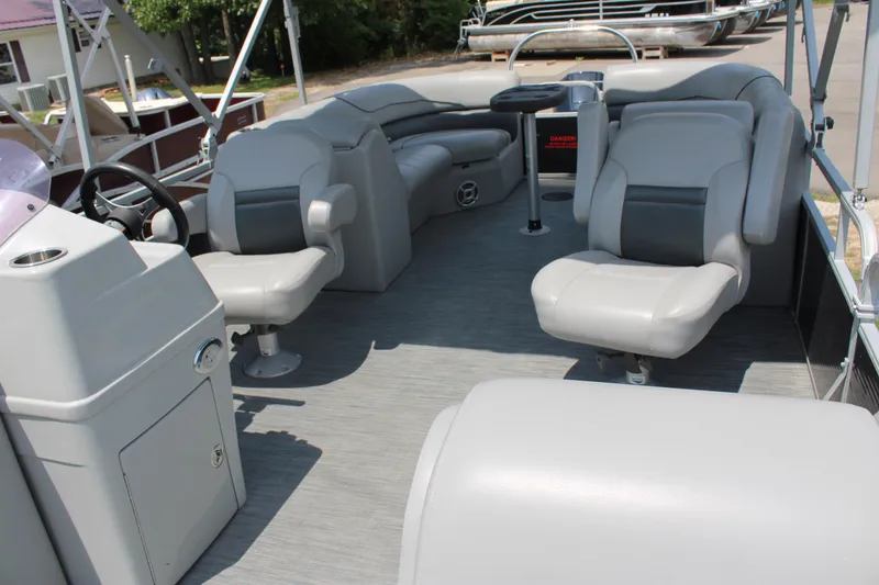 Slide: The Image of 2021 Lowe SS250 Super Sport pontoon boat interior with gray seating and helm station. - 7