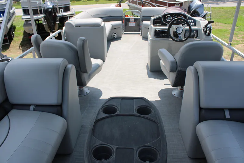 Slide: The Image of 2021 Lowe SS250 Super Sport pontoon boat interior with gray seating and steering console. - 8