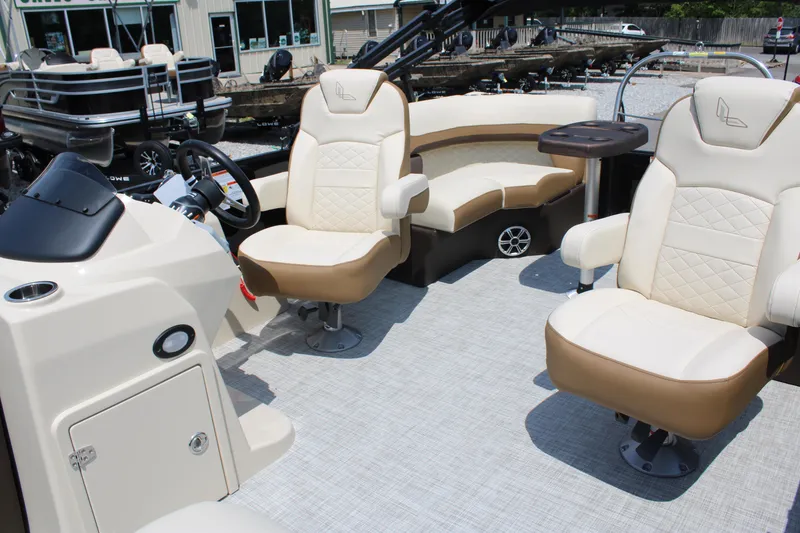 Slide: The Image of 2023 Lowe SS210 Super Sport boat interior with beige seating and steering console. - 10